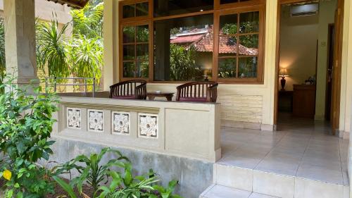 a restaurant with two chairs on a patio at Bali Sandy Resort in Kuta