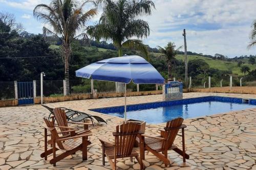 Swimming pool sa o malapit sa Santa Lucia Fazenda Centenária nas Montanhas
