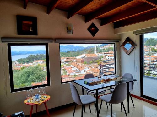 a room with a table and two chairs and windows at Sky Club - Apartamento Completo in Guatavita