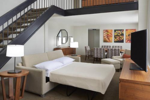 a living room with a bed and a dining room at Delta Hotels by Marriott Toronto Airport & Conference Centre in Toronto