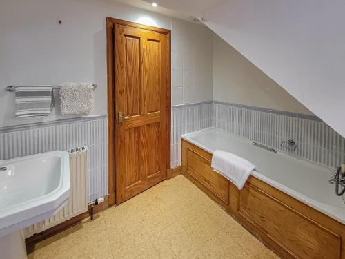 a bathroom with a bath tub and a sink at South Lodge in Banchory