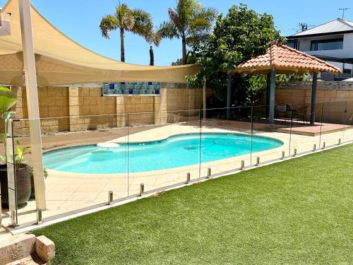 a large swimming pool with a canopy over it at Your Sunny Pool & Ocean Escape in Coogee