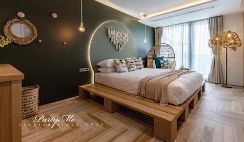 a bedroom with a large bed with a wooden bench at Party Me 派對蜜民宿 in Dongshan