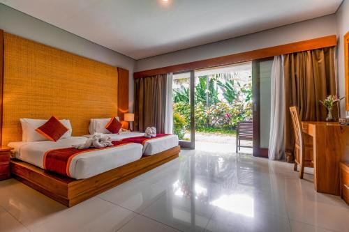Postel nebo postele na pokoji v ubytování Pertiwi Bisma Ubud