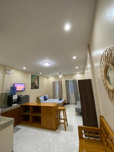 a living room with a desk and a table at Studio Type Apartment 2 with Pool and Tennis Court in Alburquerque