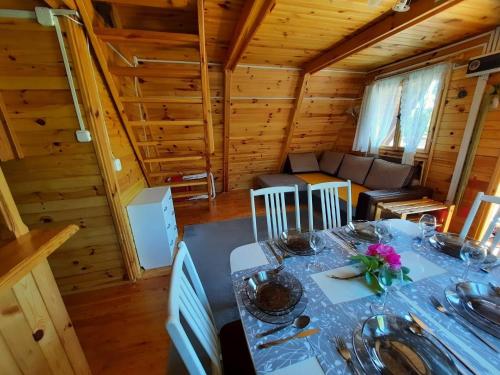 a dining room with a table in a cabin at A comfortable house with a private garden, Rusinowo in Rusinowo