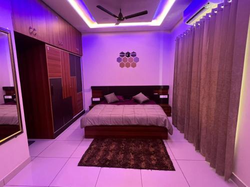 a bedroom with a bed with purple lighting at Luxury 3bhk villa (mere bebe da villa)@gopal nagar in Jalandhar