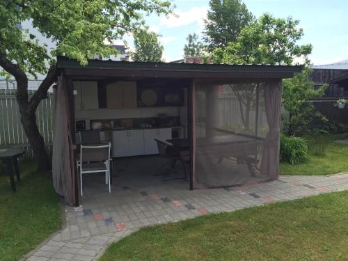 a gazebo with a table in a yard at House in the Garden in Pärnu