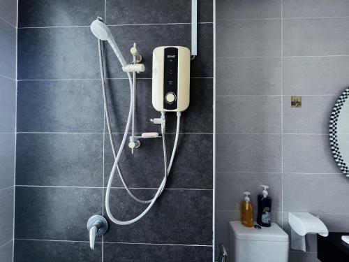 a shower in a bathroom with a shower head at Ipoh Town Family Suite w Balcony[8pax]FREE Parking in Ipoh