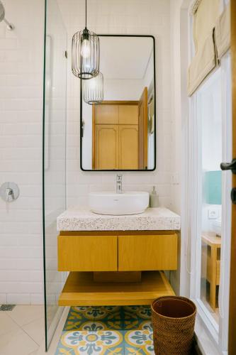 a bathroom with a sink and a mirror at Casa Amarta Canggu - Boutique Lofts & Detox SPA in Canggu
