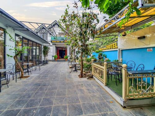 a patio with tables and chairs in a building at The Mountain View Homestay in Ninh Binh