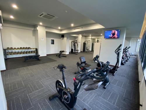 a fitness room with treadmills and exercise bikes at Japanese Zen Room Citra Plaza Nagoya Batam in Nagoya