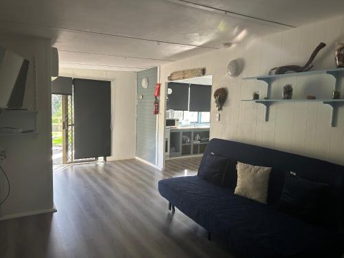 a living room with a blue couch in a room at Second Valley Caravan Park in Second Valley