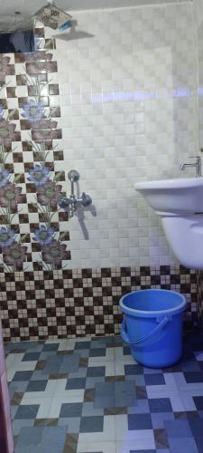 a bathroom with a toilet and a sink and a tub at Aryan residency in Māvalli