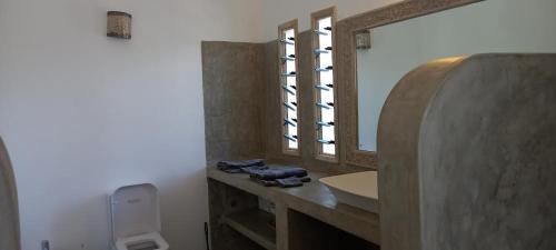 a bathroom with a sink and a mirror at 765 Breezebay suites in Watamu