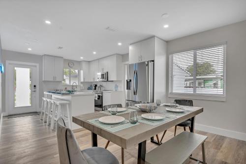 a kitchen and dining room with a table and chairs at Chic Gated 4 Bd 3 Bth Home w BBQ 15 Min to Beach in Miami