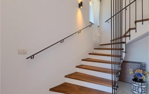 a stairway with white walls and wooden stairs at Villa Unka in Potpićan