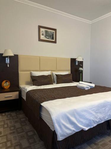 a hotel room with two beds in a room at Tanzharyk Hotel in Aktobe