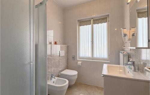 a white bathroom with a toilet and a sink at Villa David in Poreč