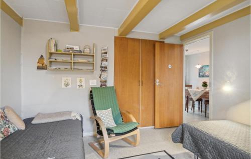 a room with a bed and a chair and a table at Cozy Apartment In Faaborg With Kitchen in Fåborg