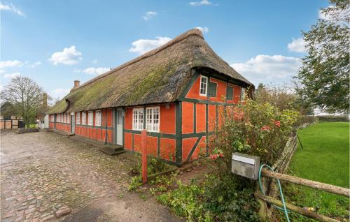 an old red house with a thatched roof at Cozy Apartment In Faaborg With Kitchen in Fåborg