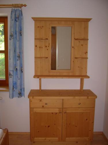 a wooden dresser with a mirror on top of it at Biohof Teufel in Lunz am See