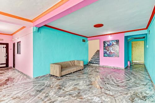 a room with blue and pink walls and a couch at OYO Hotel Wonder Hills in Hinjewadi