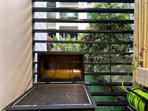a metal bench sitting on a balcony next to a building at BNB Cozy Homestay @ Cyberjaya in Cyberjaya