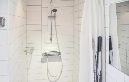 La salle de bains est pourvue d'une douche avec rideau de douche. dans l'établissement Cozy Home In Henn With Kitchen, à Henån