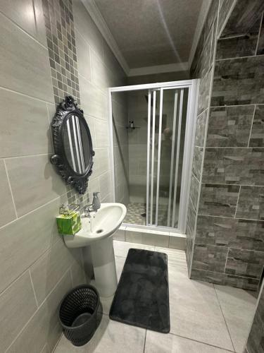 a bathroom with a sink and a shower at 5 on Crossways in East London
