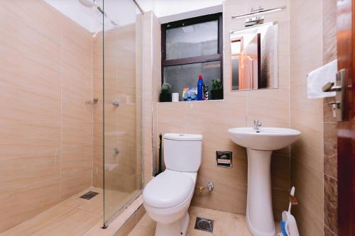 a bathroom with a toilet and a sink and a shower at Ruaka Radiance 2-Bed Escape in Ruaka