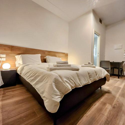 a bedroom with a large bed with a wooden headboard at b&b marconi 49 in Bologna