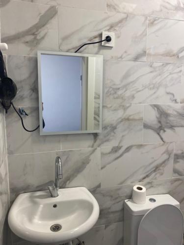 a bathroom with a sink and a mirror and a toilet at yenikapı hotel in Istanbul