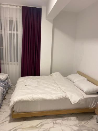 a white bed in a room with a window at yenikapı hotel in Istanbul