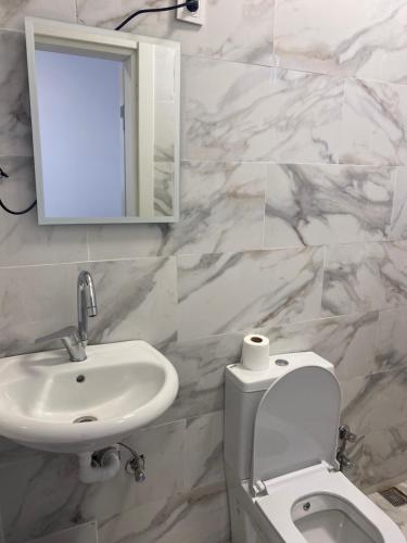 ein Badezimmer mit einem Waschbecken, einem WC und einem Spiegel in der Unterkunft yenikapı hotel in Istanbul