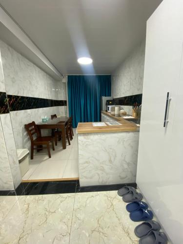 a kitchen with a table and a dining room at Etuga Guesthouse, Close to Sukhbaatar Square in Ulaanbaatar