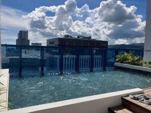 a swimming pool on the roof of a building at 38 Park Avenue right in the heart of IT Park Cebu, 55 inches TV, wifi in Tabok