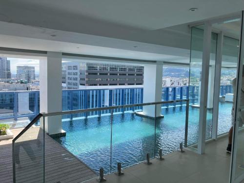 a large swimming pool in the middle of a building at 38 Park Avenue right in the heart of IT Park Cebu, 55 inches TV, wifi in Tabok