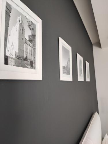 a bedroom with three pictures on a wall at LianHome b&b "Terrazzino" in Lucera