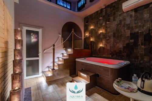 a bathroom with a red tub and a staircase at Hotel Bella 'Mbriana in Follonica