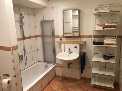 a bathroom with a sink and a shower and a bath tub at Wohlfühl- Wohnung in Osthofen