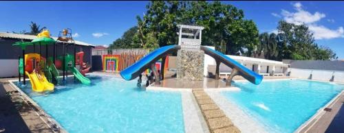 a pool with a water park with a slide in it at Orlando Beach Resort in Lemery