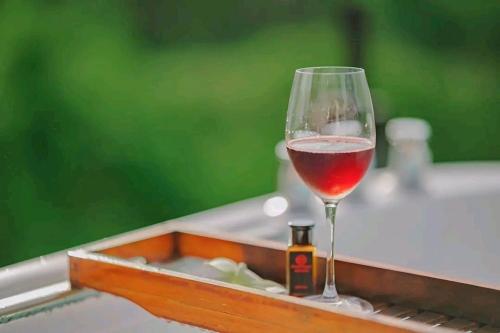a glass of wine sitting on top of a tray at Black Diamond Camping in Khao Kho
