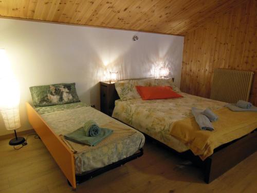 a bedroom with two beds and a lamp in a room at AVD - Residence Palma in Udine
