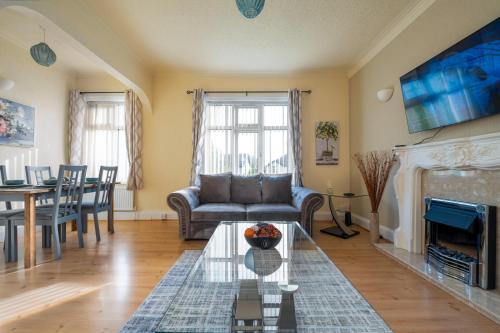 a living room with a couch and a table at Spacious Apartment - Parking - Sleeps 5 in Great Coates
