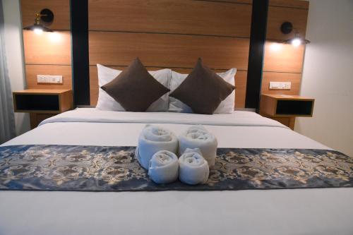 a bedroom with a bed with two candles on it at The Base Inn Pattaya in Pattaya Central