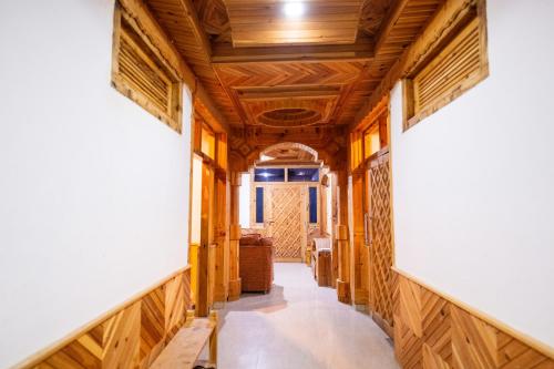 a hallway with wood paneling and a ceiling at Norvin Homes in Shimla