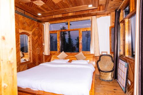 a bed in a wooden room with a window at Norvin Homes in Shimla