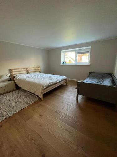 a bedroom with two beds and a window at Ģimenes māja Jaunpilī in Jaunpils