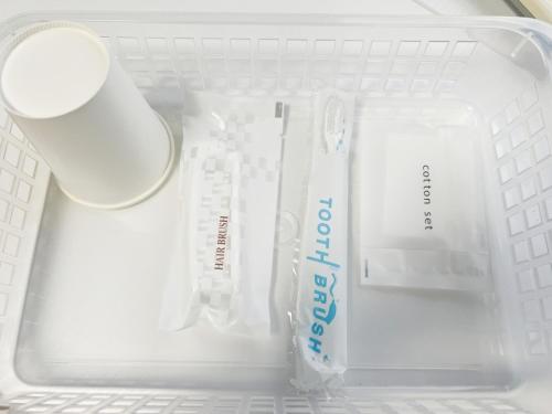 a drawer with a toothbrush and a tooth paste and a toothbrush at 無料駐車場有車種制限有!USjまで近く!空庭温泉徒歩圏海遊館!最大7名 in Osaka